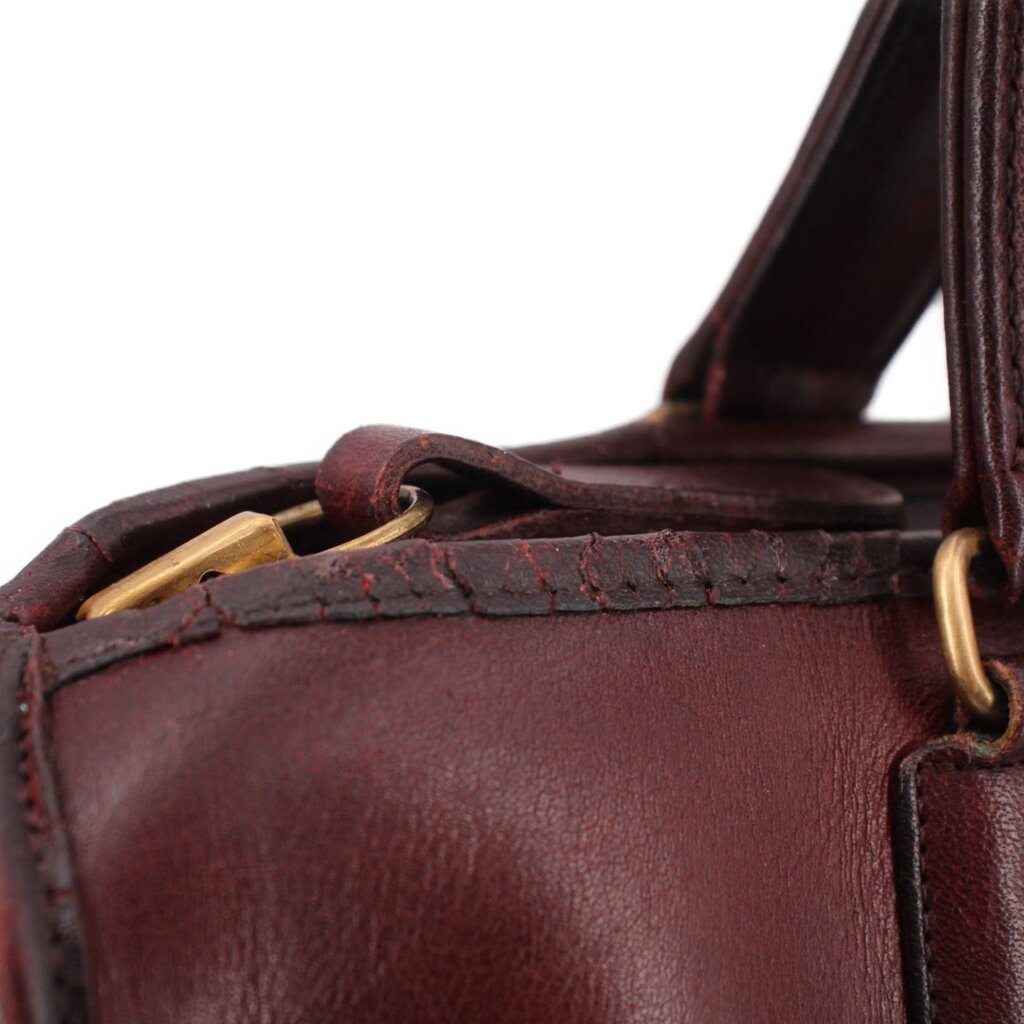 Oxblood leather satchel top opening with leather strap and brass hardware