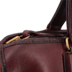 Oxblood leather satchel top opening with leather strap and brass hardware