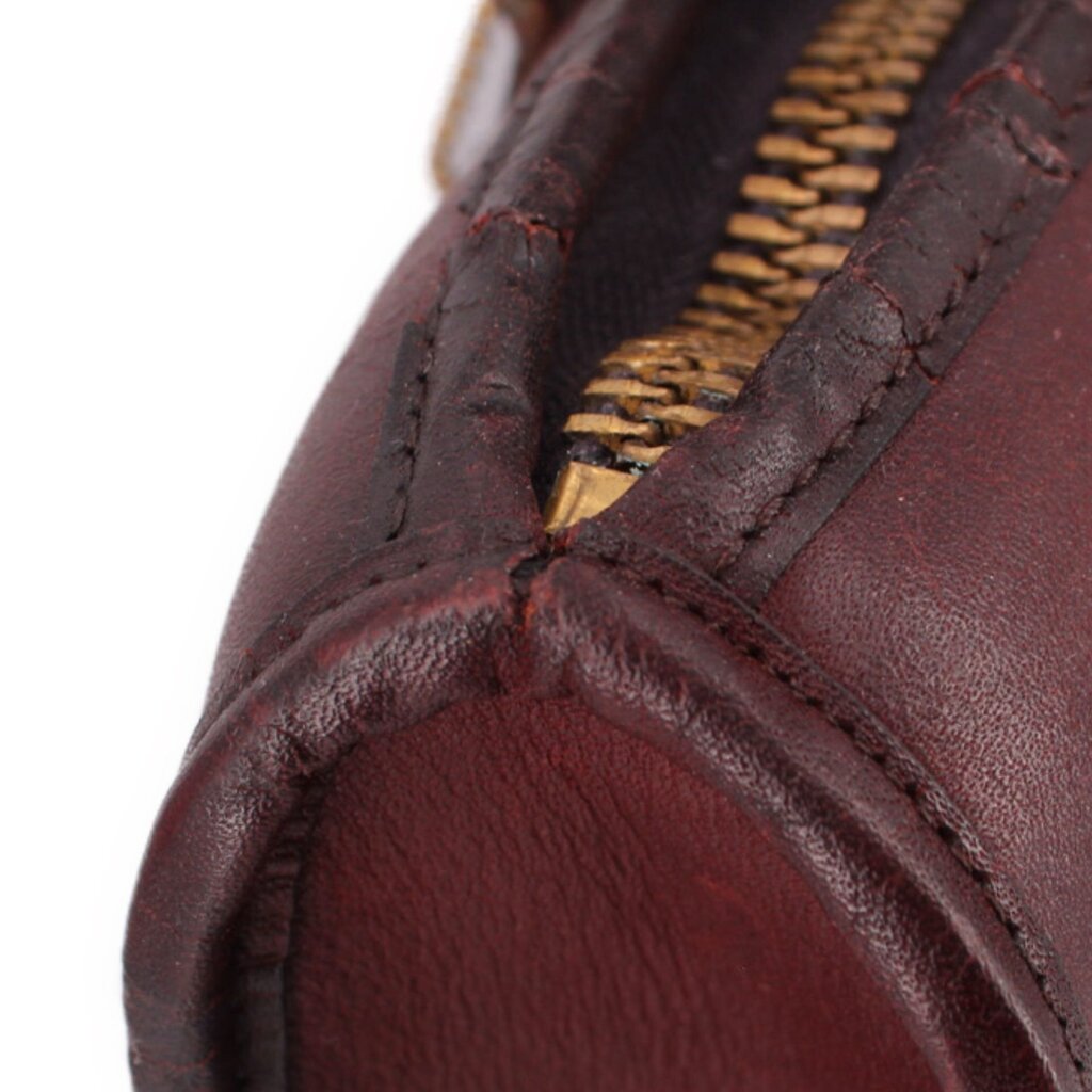 Slim satchel interior view with zipper track and burgundy leather lining