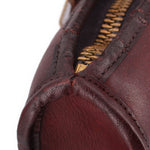 Slim satchel interior view with zipper track and burgundy leather lining