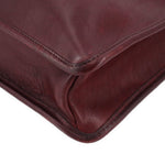 Oxblood leather satchel corner with reinforced stitching and rounded shape