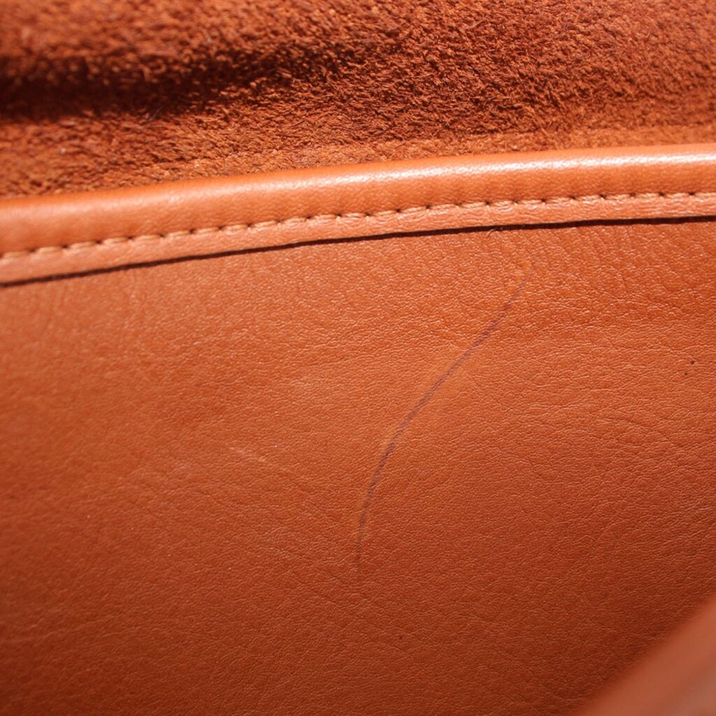 British tan leather interior panel with visible stitching seam and textured finish