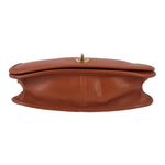 British tan leather crossbody bag top view with turn-lock hardware and handle loop