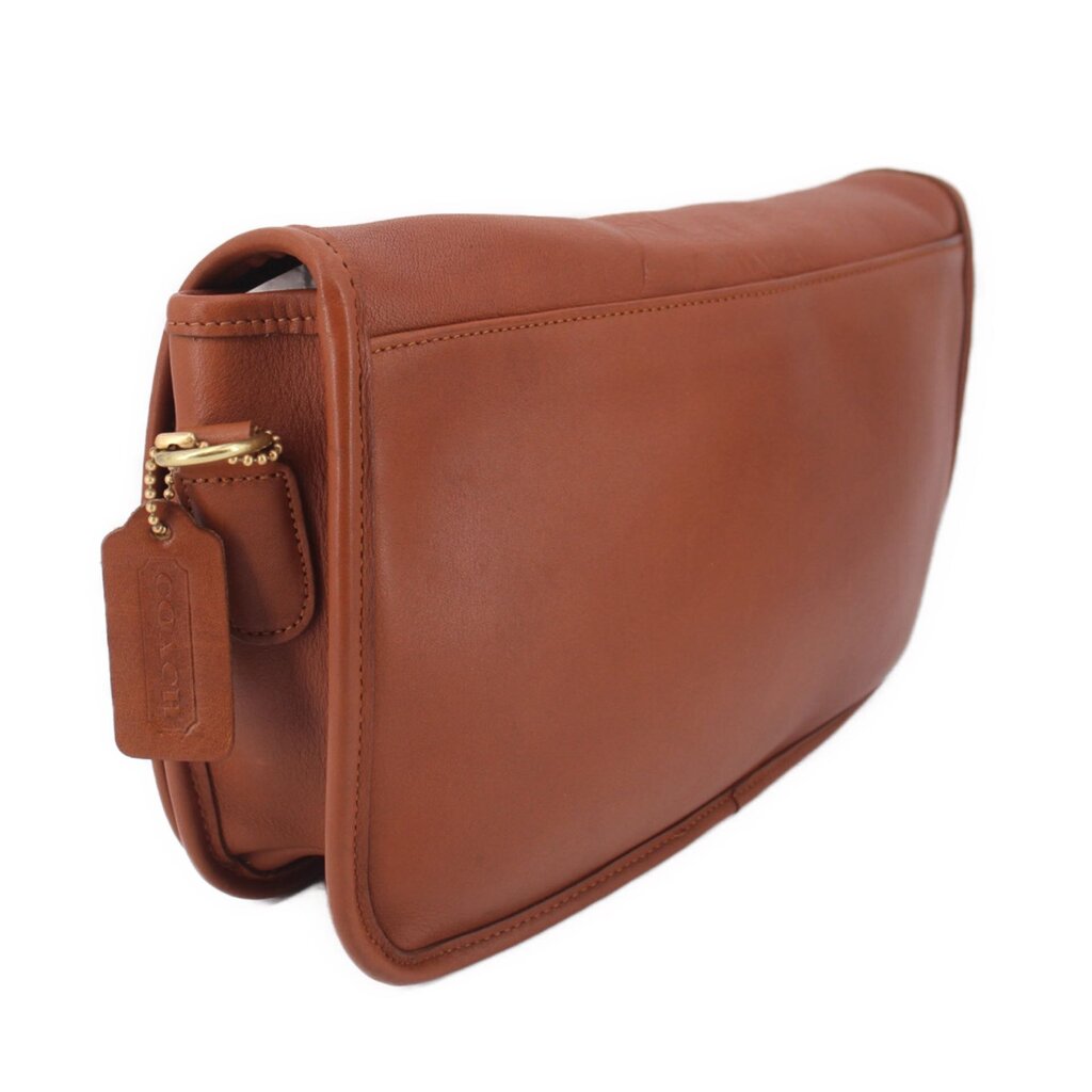 British tan leather crossbody bag angled side view with metal details and strap loop