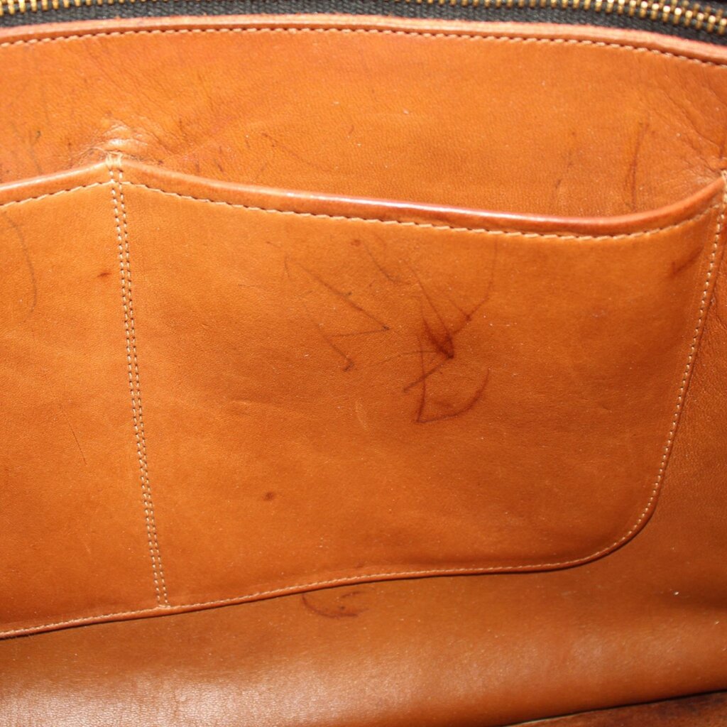 British tan leather tote interior pocket with visible stitching and embossed marks