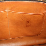 British tan leather tote interior pocket with visible stitching and embossed marks