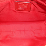 Red fabric-lined interior with small leather label and embossed COACH branding