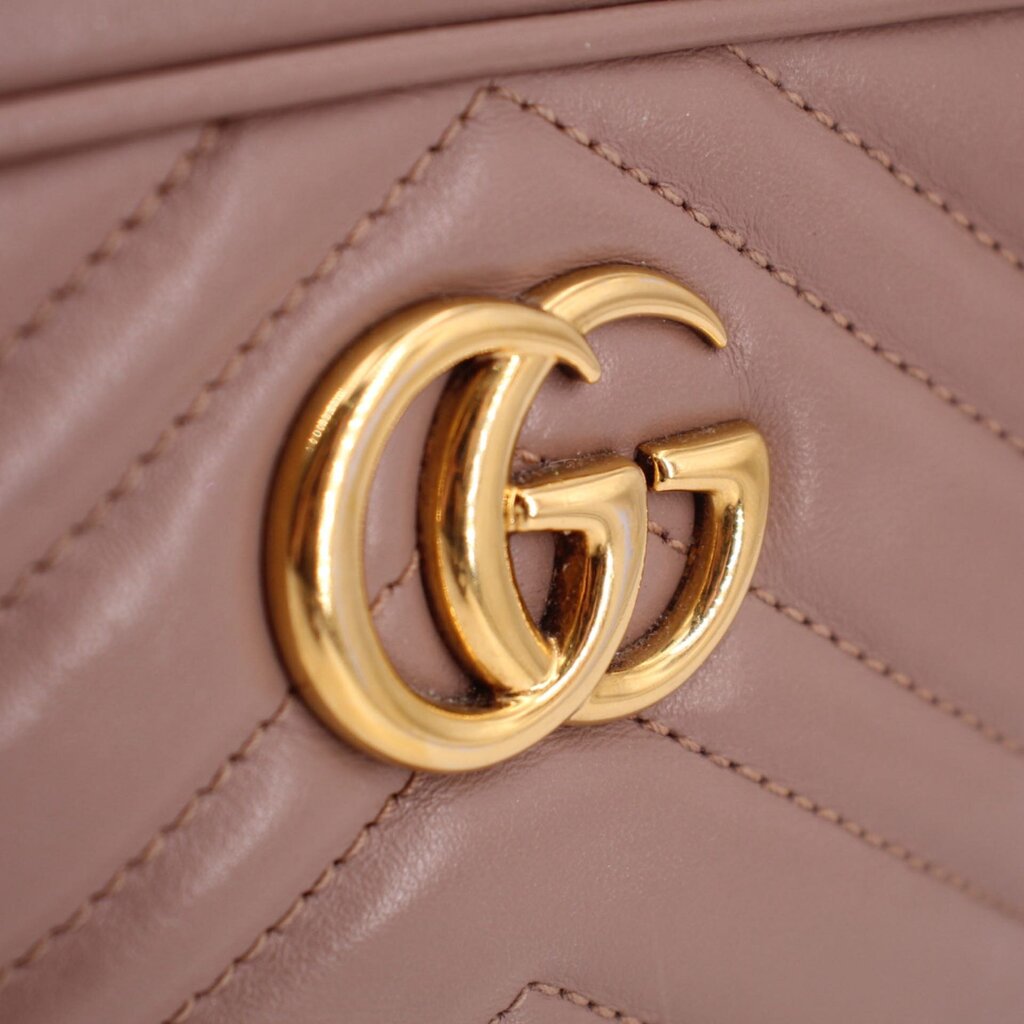 Gold-tone GG logo detail on taupe quilted leather crossbody bag