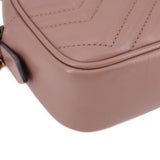 Taupe leather crossbody bag bottom corner with stitched seams and strap attachment