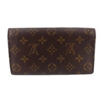 Monogram leather wallet with fold-over flap and smooth profile
