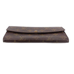 Monogram leather wallet with fold-over flap and center gold-tone snap