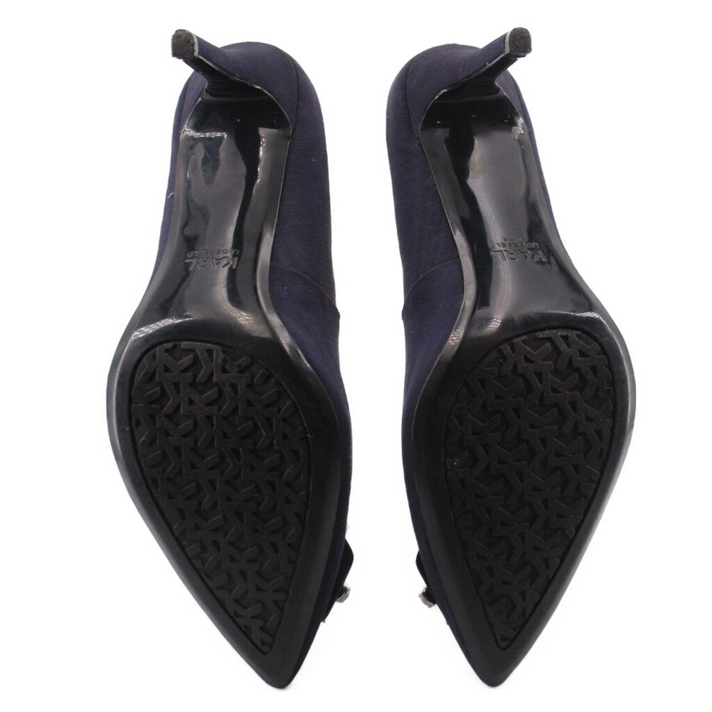 Navy high-heel shoes, underside view with textured black rubber sole