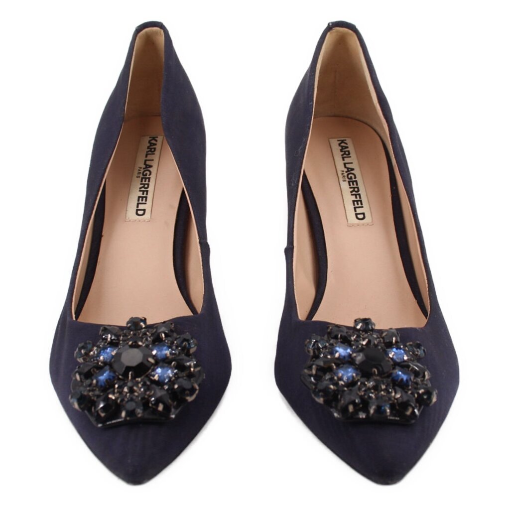 Pair of navy pointed-toe heels with jeweled front cluster and tan lining