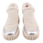 Pair of silver suede platform boots with faux-fur cuffs and ridged soles