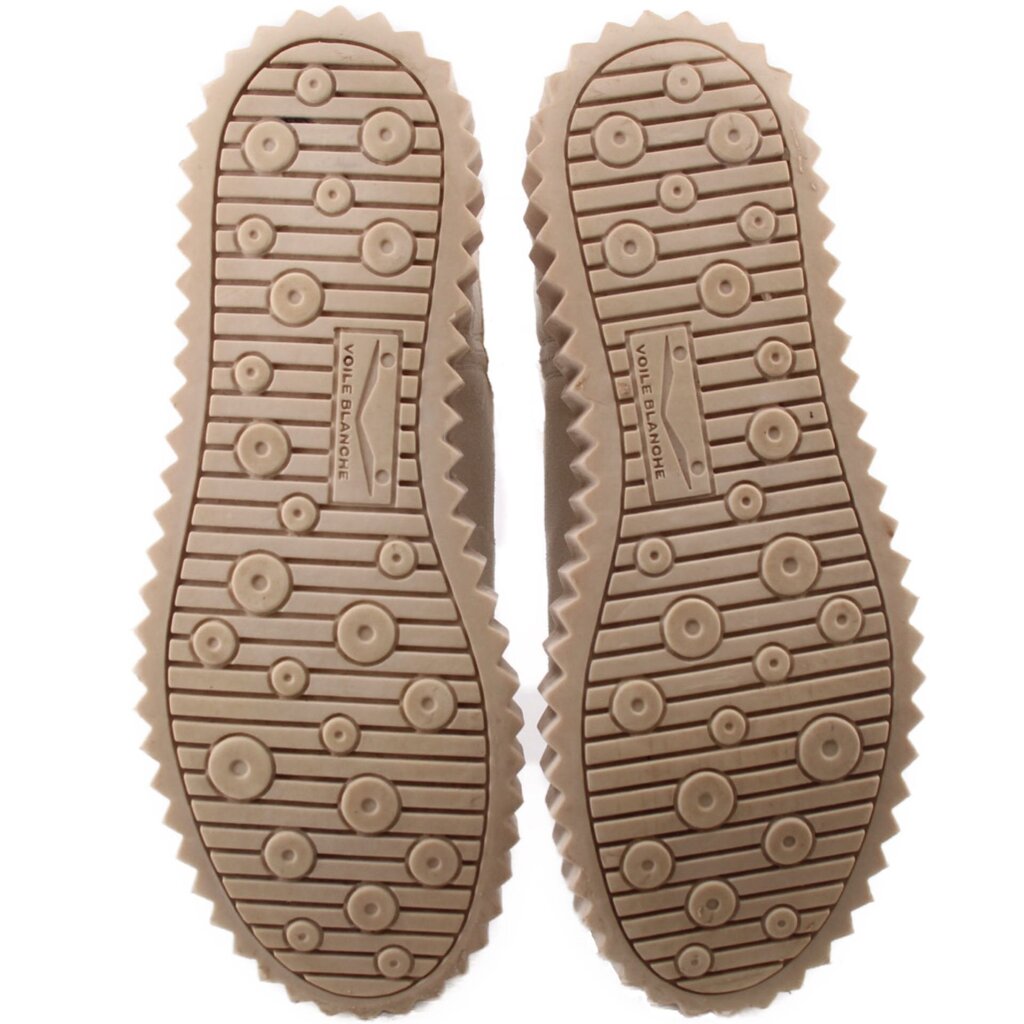 Outsoles of silver platform boots with patterned rubber tread