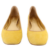 Yellow suede ballet flats, rounded interior opening and stitched topline