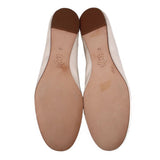 Inside view of ivory satin flats with cushioned insole