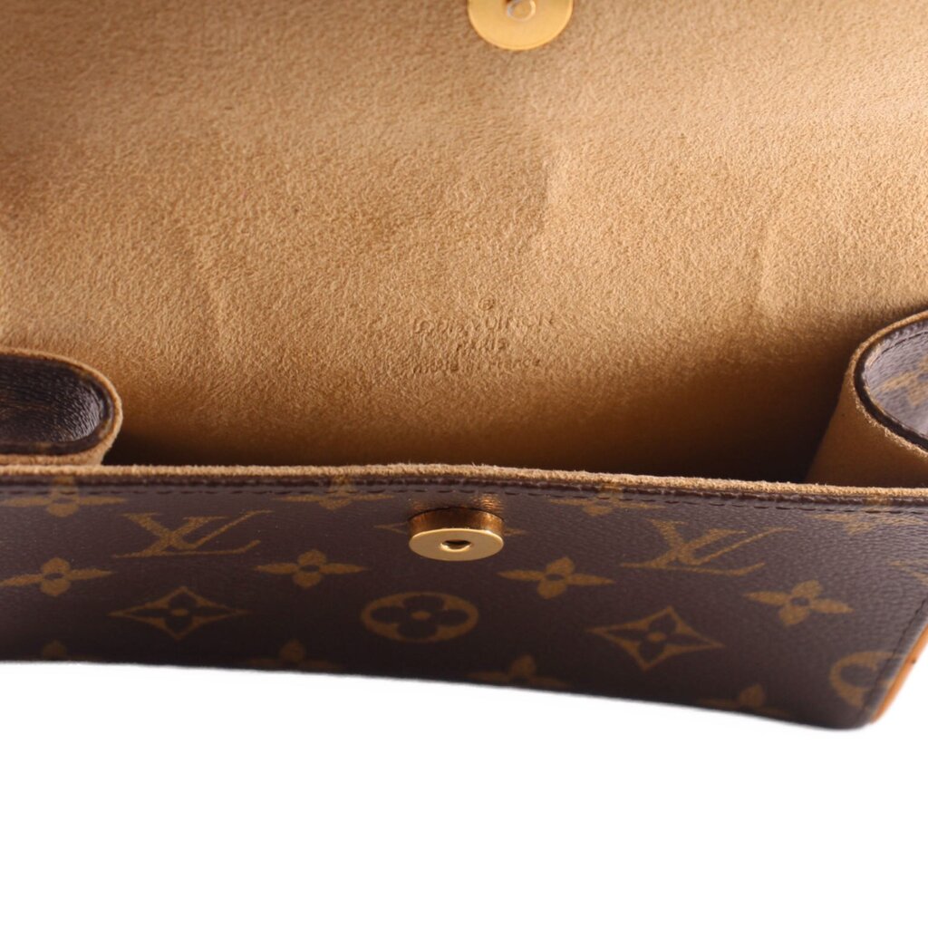 Close-up of monogram belt bag interior with tan lining and gold snap stud