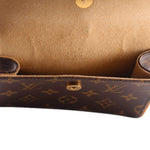 Close-up of monogram belt bag interior with tan lining and gold snap stud