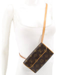 Monogram belt bag worn crossbody on chest, brown exterior with tan strap