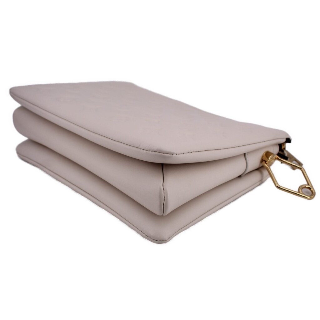 LOUIS VUITTON Coussin MM crossbody bag in white, angled side view with gold clasp