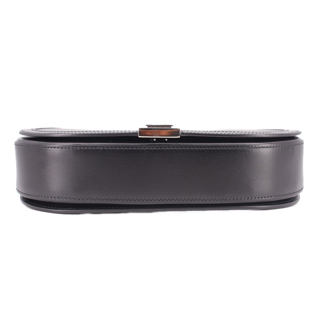 Black leather shoulder bag base view with contrast stitching and metal clasp