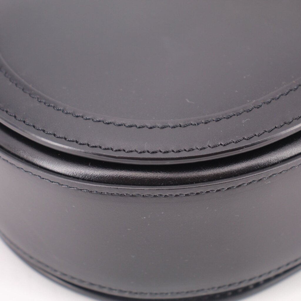 Black leather shoulder bag close-up of double stitched trim along the curve