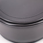 Black leather shoulder bag close-up of double stitched trim along the curve