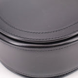Black leather shoulder bag close-up of double stitched trim along the curve