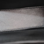 Black leather bag close-up of interior panel with stitched seam
