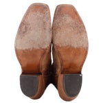 Brown cowboy boots showing heels and outsoles with stacked wood heel and dark pads