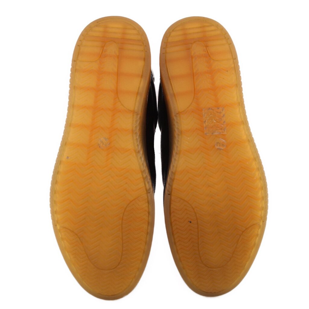 Black sneaker outsoles showing textured gum rubber tread