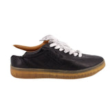 Black leather low-top sneaker with white laces and textured gum sole