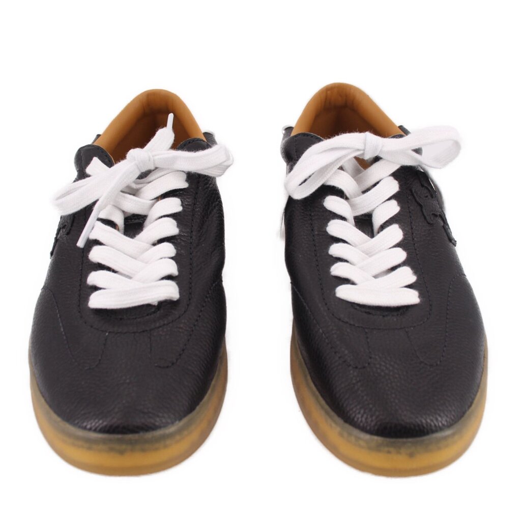 Pair of black leather sneakers with white lace-up detail and gum soles