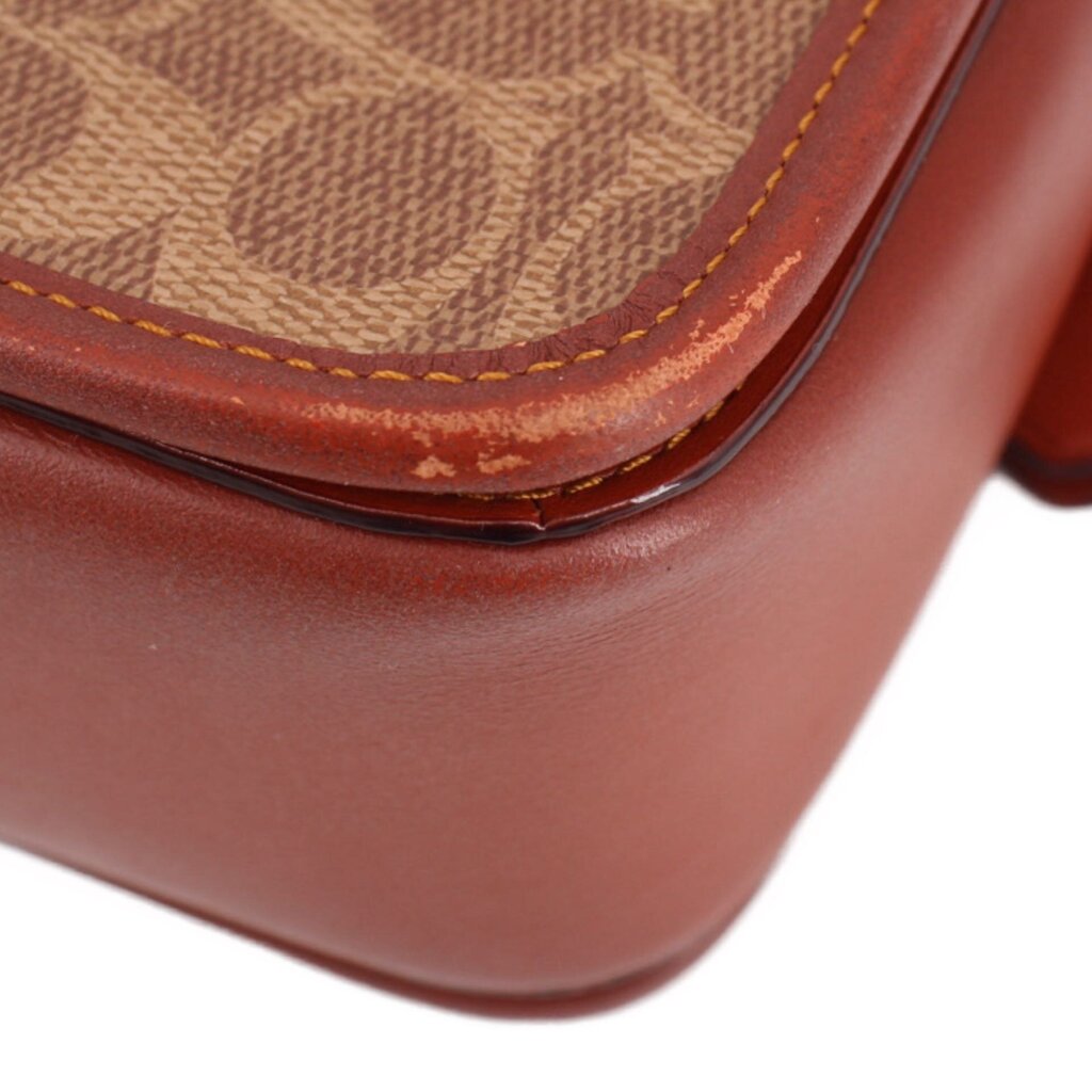 Cognac leather corner with curved seam, visible stitching, and patterned interior lining