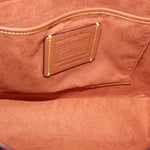 Cognac interior panel with embossed Coach patch and stitched trim