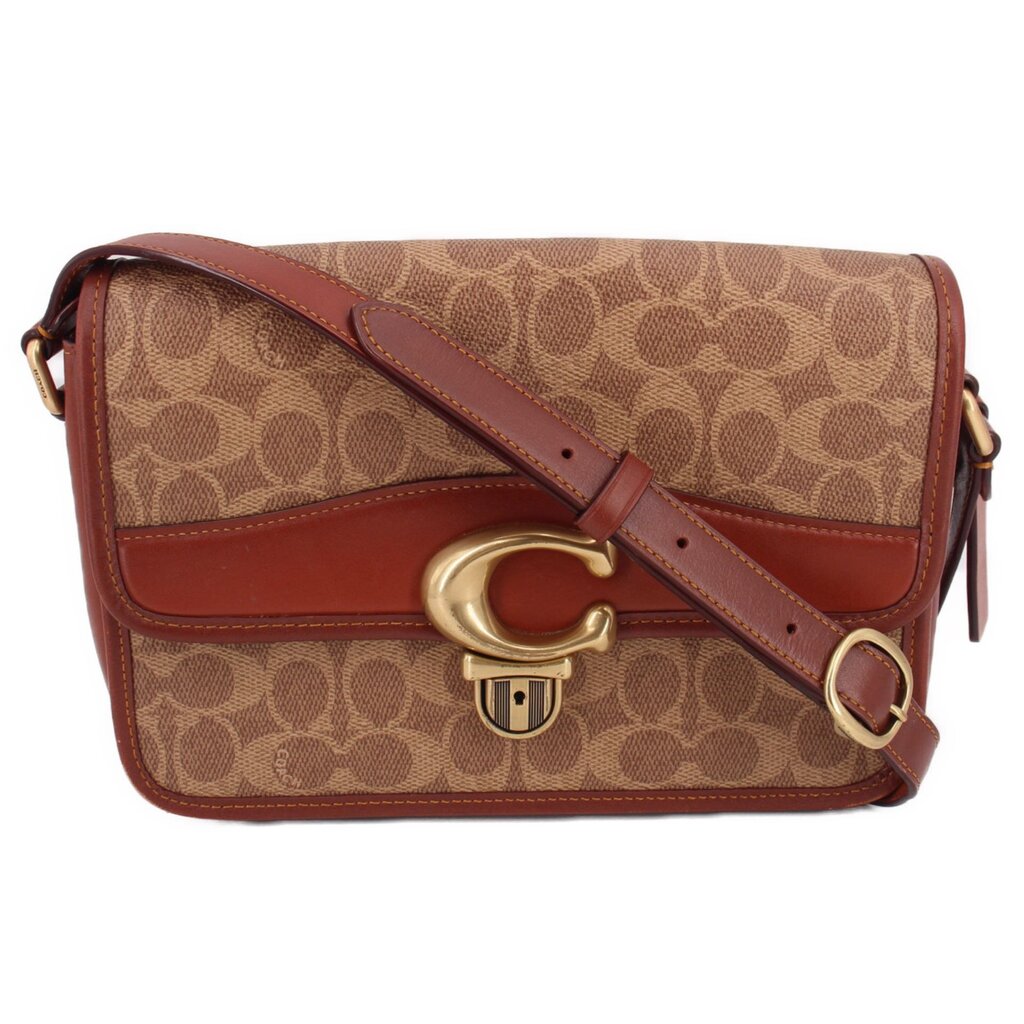 Cognac Coach canvas shoulder bag with signature monogram pattern and turn-lock flap