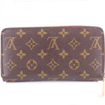 Monogram zip-around wallet front view in brown with repeating gold Louis Vuitton motif