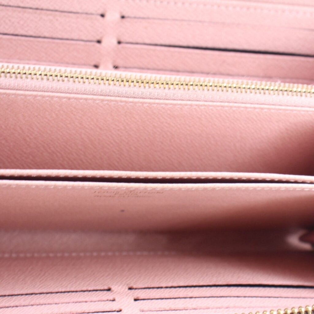 Rose pink wallet interior lining with gold zipper close-up