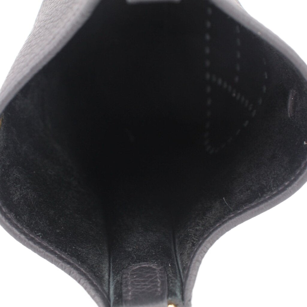 Inside of small crossbody bag, smooth black lining and seam stitching, open-top shape
