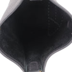Inside of small crossbody bag, smooth black lining and seam stitching, open-top shape
