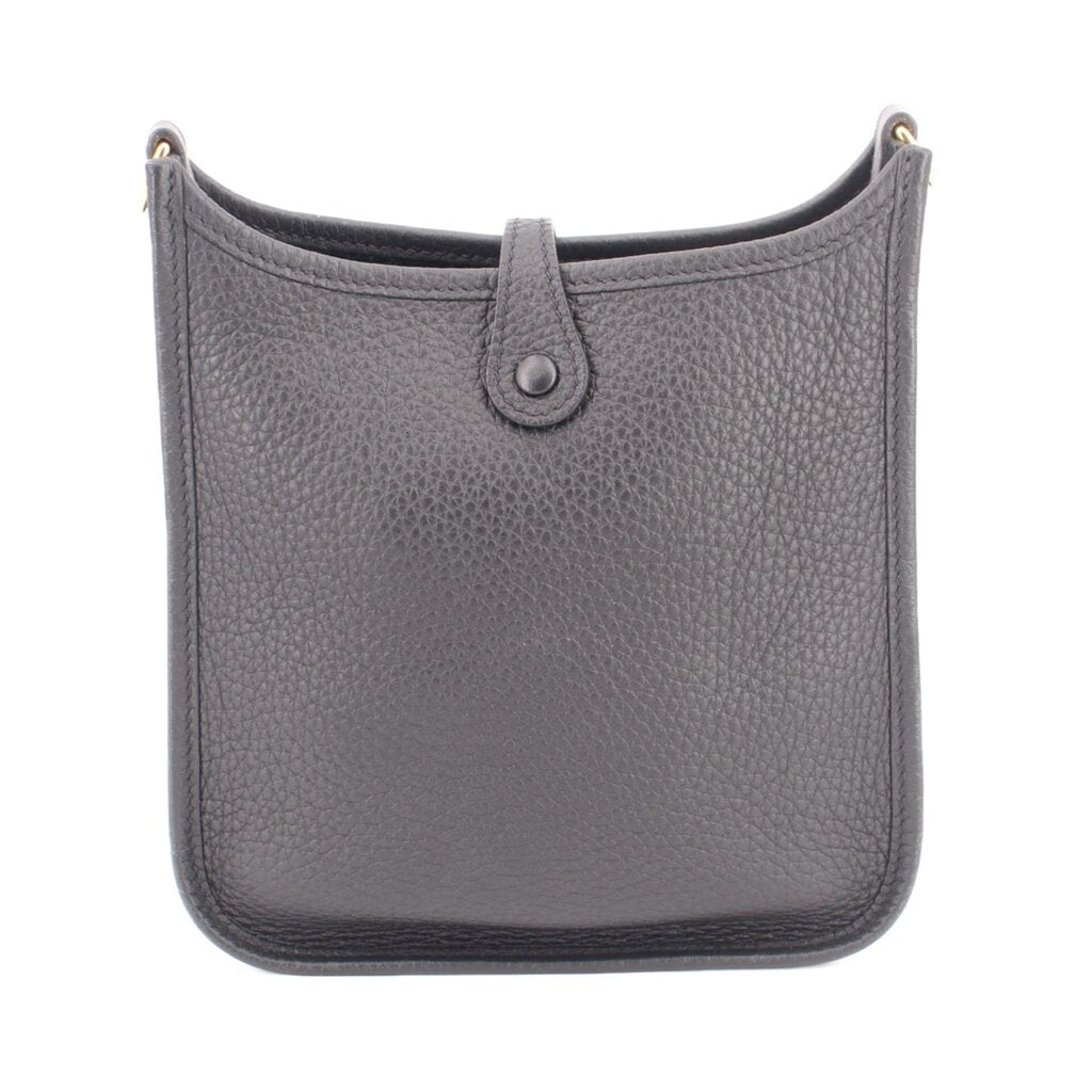 Small crossbody bag front view, textured leather, center snap closure, adjustable dark strap