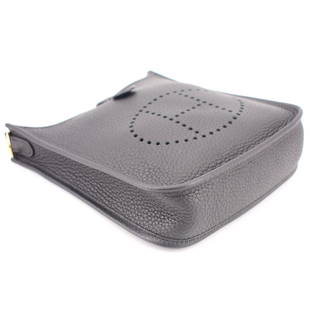 Small crossbody bag with perforated H logo on top flap, compact design, light gray leather