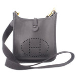 Small crossbody bag with perforated H logo, top snap, adjustable strap, dark leather