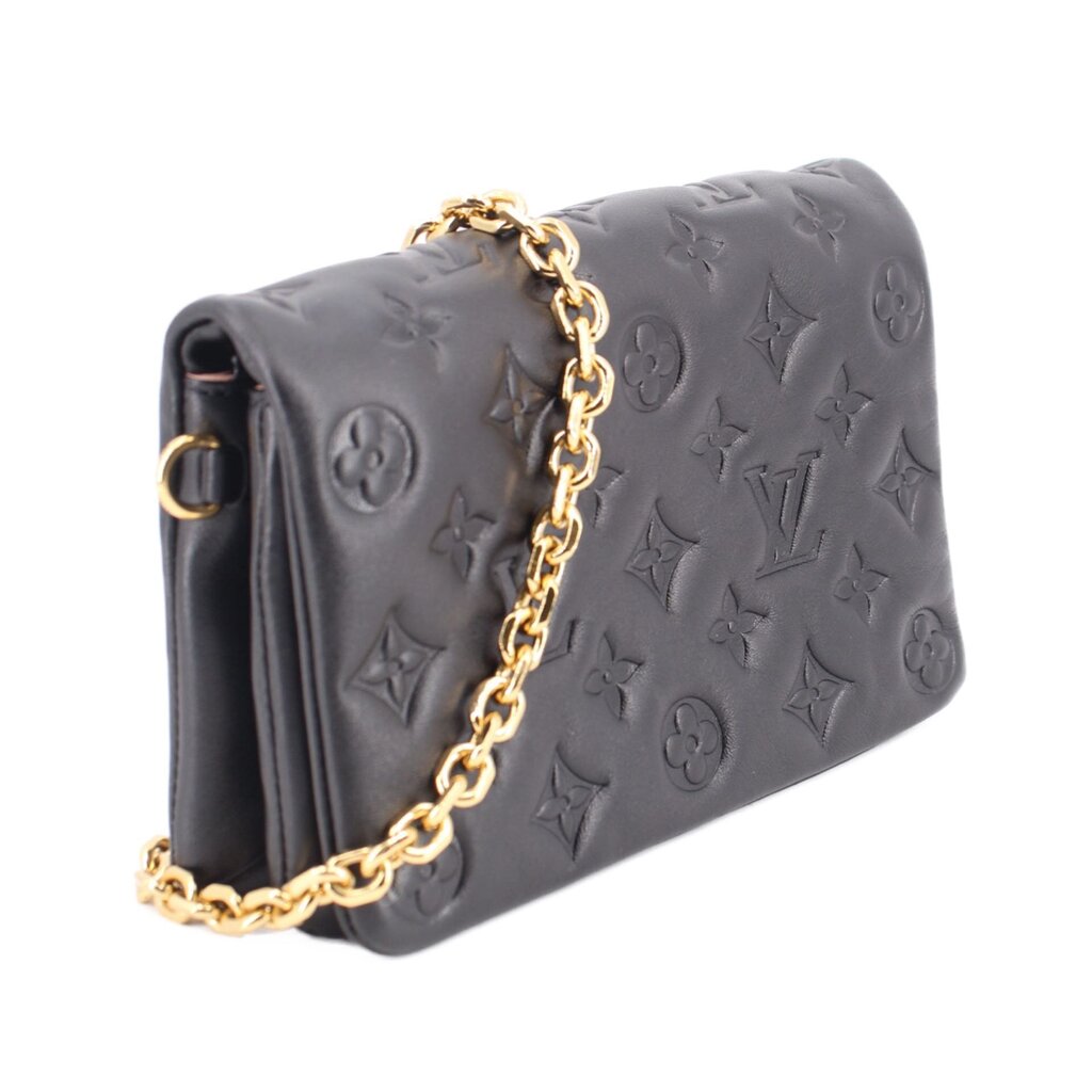 Black embossed monogram crossbody bag with gold chain shoulder strap