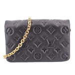Black embossed monogram crossbody bag with gold chain strap and zipper closure