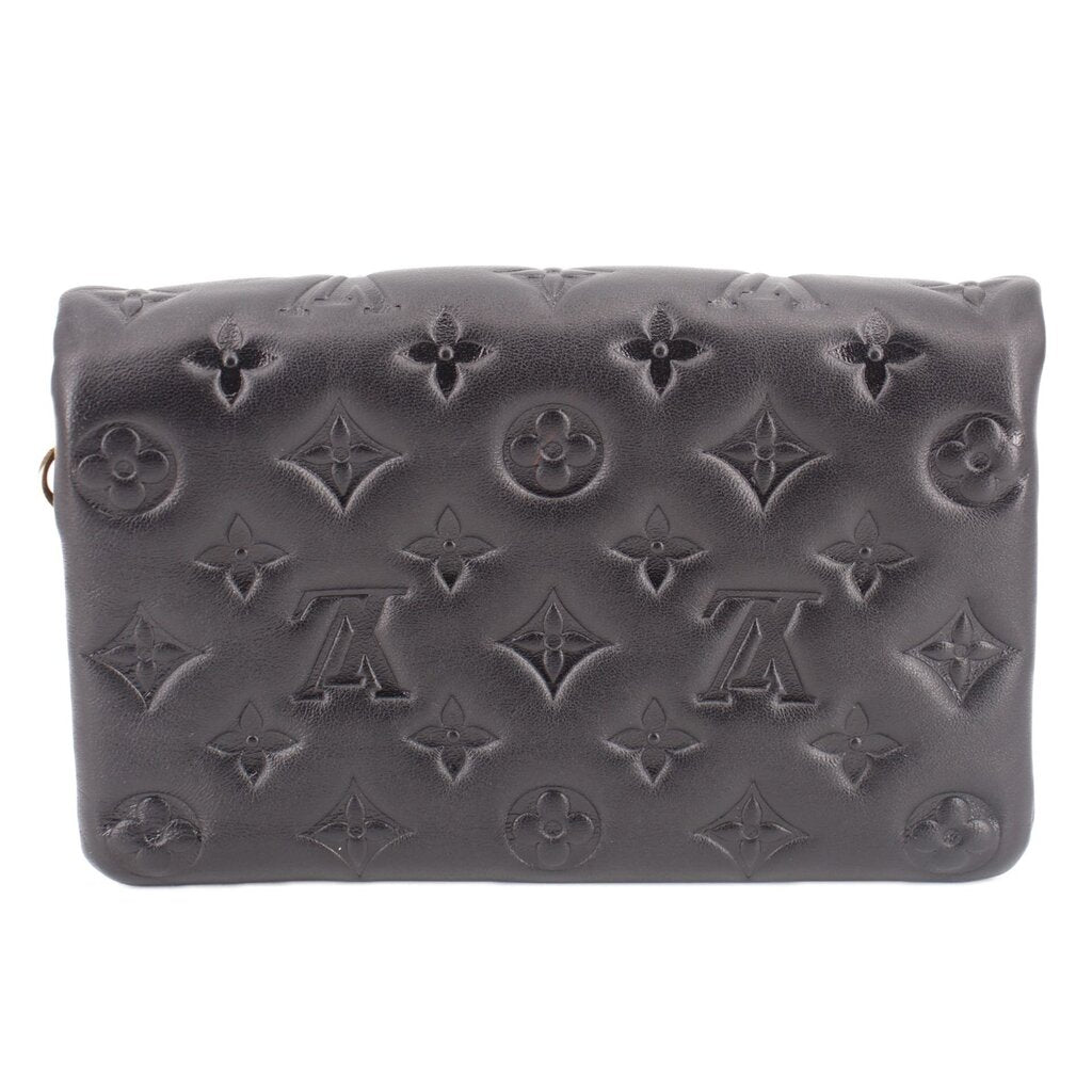 Black embossed monogram crossbody bag with zipper top and curved front