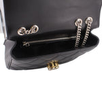 Black shoulder bag interior view with chain strap, zip pocket, and hardware details.