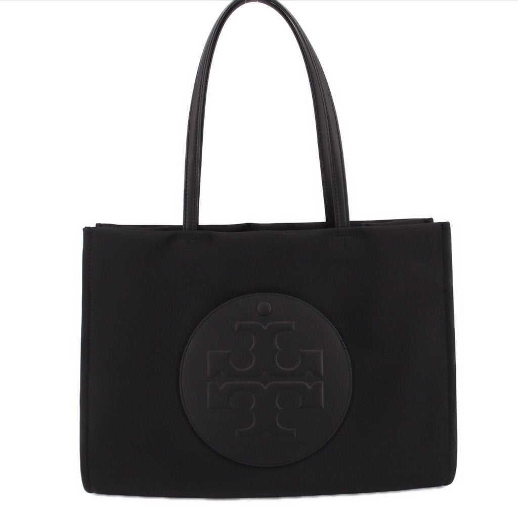 Black small Ella tote bag with oval logo patch on front and two top handles