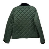 Back view of quilted green jacket with black collar and snap buttons